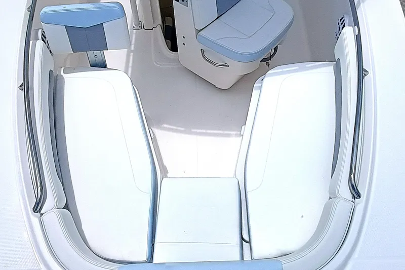 Slide: The Image of 2025 Robalo R202 Explorer boat interior with white and blue seating arrangement. - 12