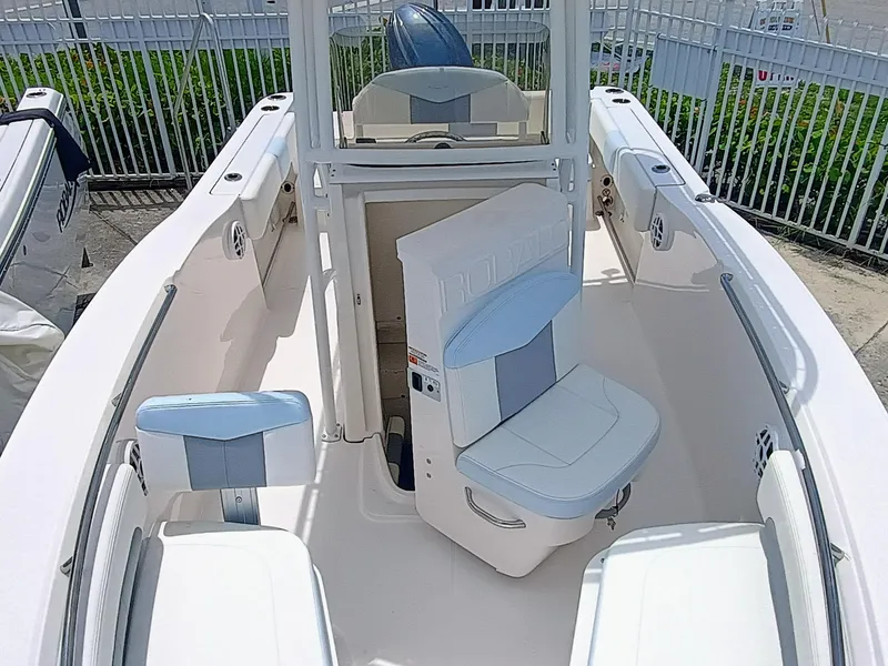 Slide: The Image of 2025 Robalo R202 Explorer boat interior with seating and console, docked outdoors. - 13