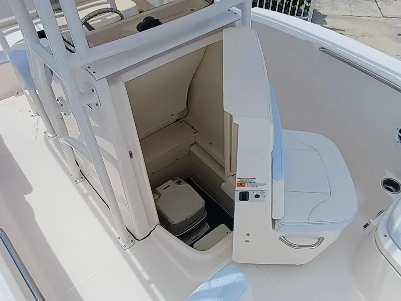 Slide: The Image of 2025 Robalo R202 Explorer boat interior with storage compartment and seating. - 14