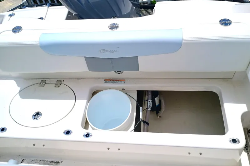 Slide: The Image of 2025 Robalo R202 Explorer boat interior with storage compartments and seating. - 17