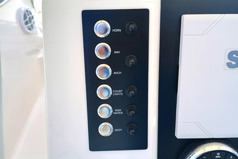 Slide: The Image of Control panel of 2025 Robalo R202 Explorer boat with labeled buttons for various functions. - 19