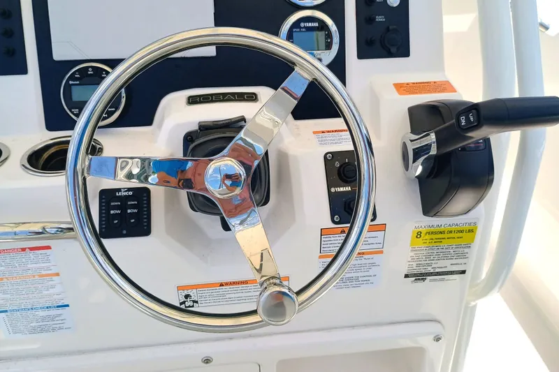 Slide: The Image of Steering wheel and controls of 2025 Robalo R202 Explorer boat. - 21