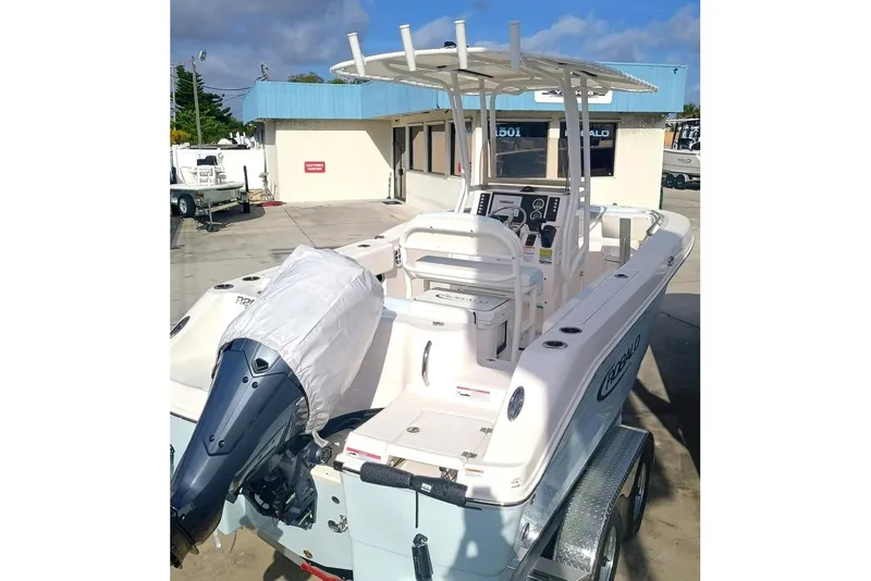 Slide: The Image of 2025 Robalo R202 Explorer boat with covered engine, parked on a trailer. - 7