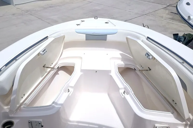 Slide: The Image of 2025 Robalo R202 Explorer boat with open storage compartments on deck. - 9