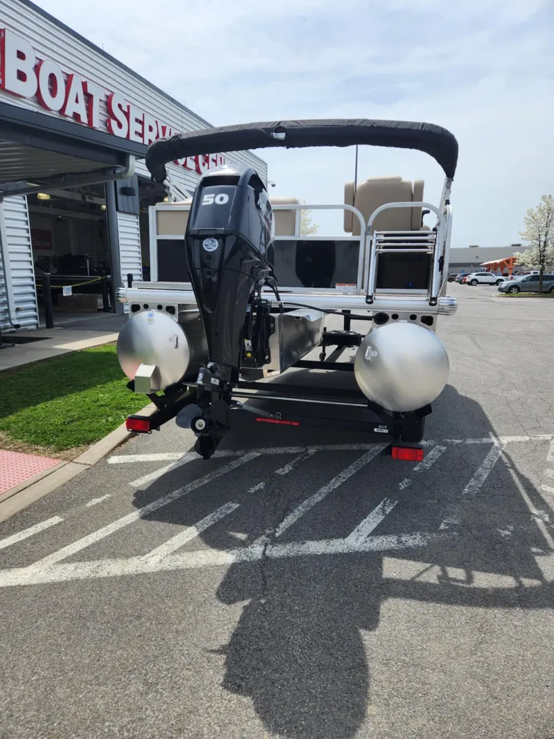 Slide: The Image of 2025 Sun Tracker Party Barge 16 DLX pontoon boat at a service center. - 4