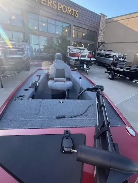 Slide: The Image of 2025 Tracker Panfish 17 boat displayed at a dealership, featuring a sleek design and modern seating. - 3