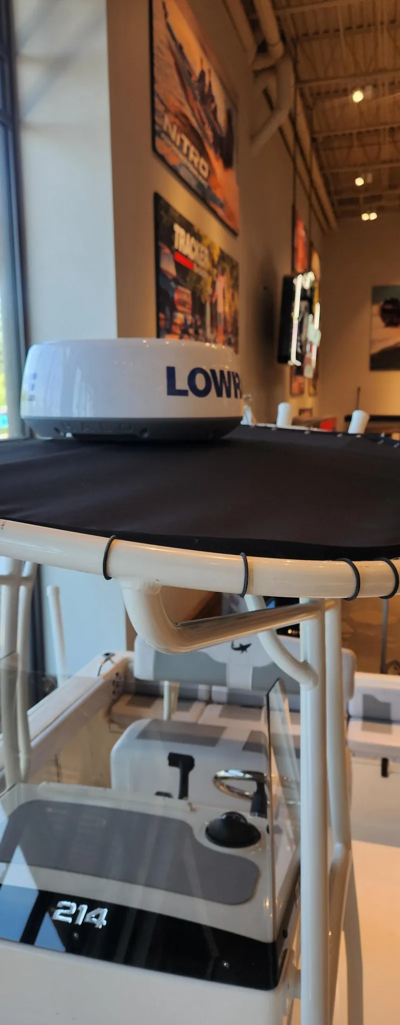 Slide: The Image of 2025 Mako 214 CC boat with Lowrance radar in showroom display. - 2