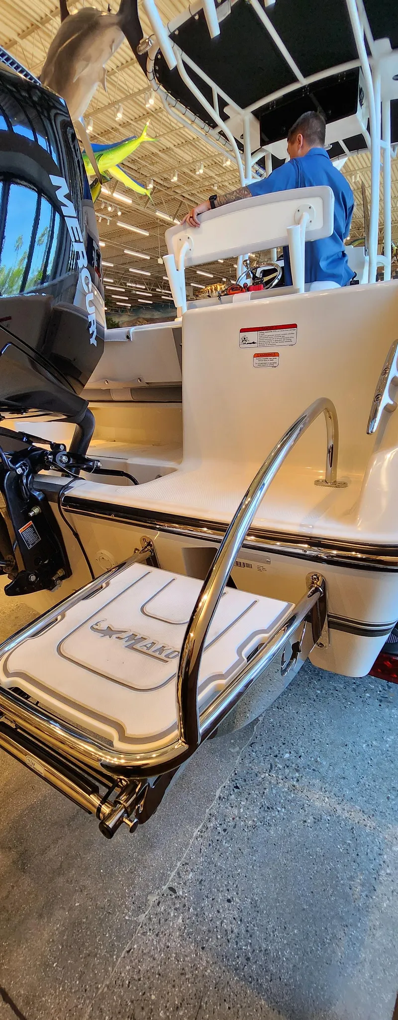 Slide: The Image of 2025 Mako 214 CC boat with swim platform and ladder in showroom. - 3