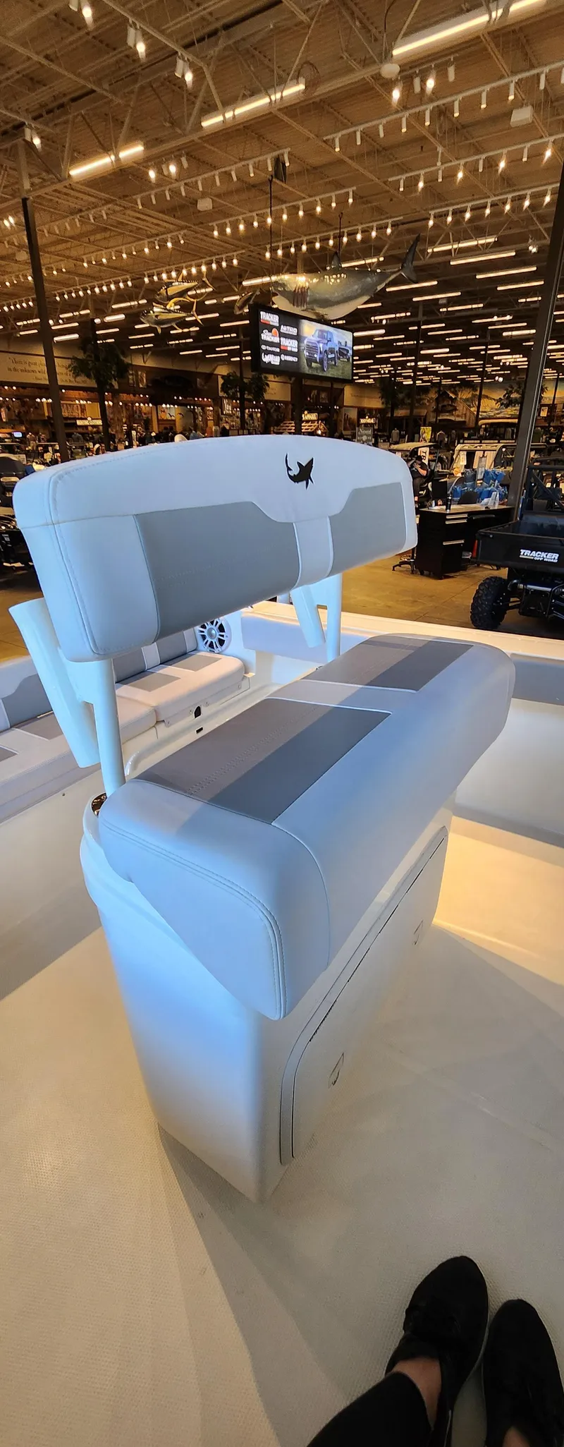 Slide: The Image of 2025 Mako 214 CC boat interior with seating, displayed in a showroom. - 4
