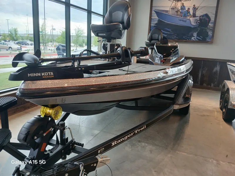 Slide: The Image of 2025 Ranger Z518 boat with Minn Kota motor displayed indoors. - 12