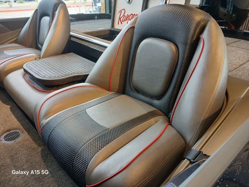 Slide: The Image of 2025 Ranger Z518 boat seats with black and gray upholstery, red accents, and center console. - 15