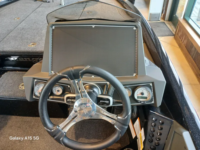 Slide: The Image of 2025 Ranger Z518 boat dashboard with steering wheel and gauges. - 19