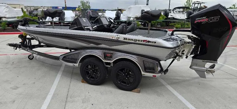Slide: The Image of 2025 Ranger Z518 boat with dual-axle trailer, parked outdoors. - 2