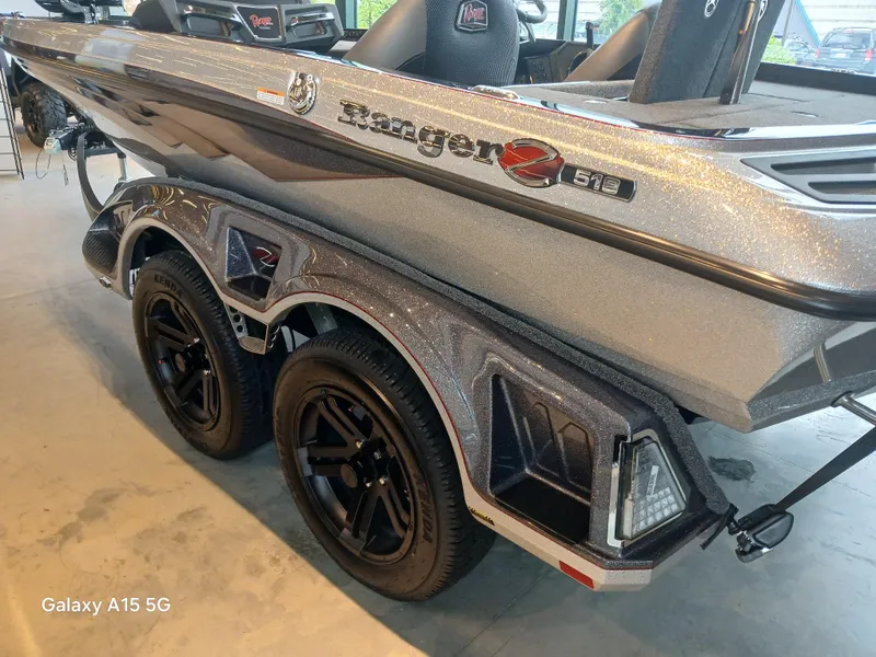 Slide: The Image of 2025 Ranger Z518 boat on a dual-axle trailer, showcasing sleek design and modern features. - 21