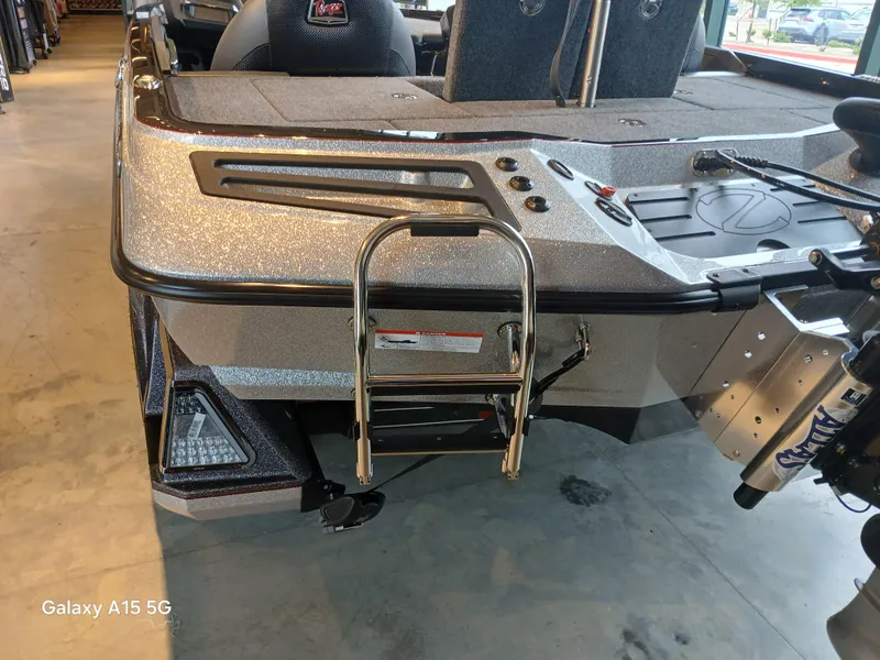 Slide: The Image of 2025 Ranger Z518 boat rear view with ladder and motor, indoors. - 22