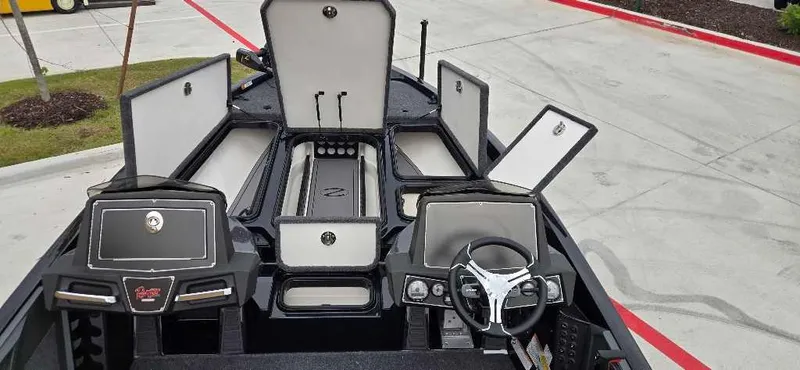 Slide: The Image of 2025 Ranger Z518 boat interior with open storage compartments and steering wheel. - 7