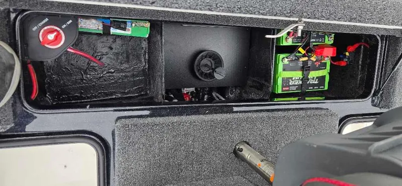 Slide: The Image of 2025 Ranger Z518 boat battery compartment with wiring and components. - 8