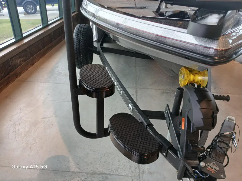 Slide: The Image of 2025 Ranger Z518 boat trailer with dual step system and winch, displayed indoors. - 9