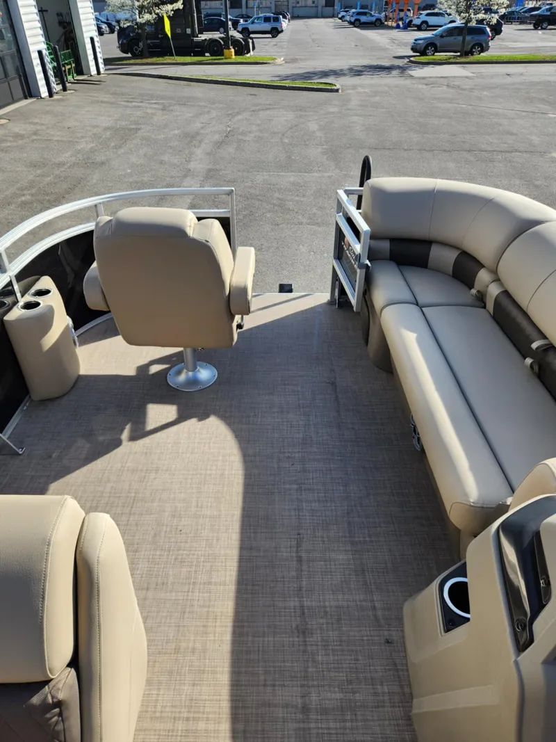 Slide: The Image of 2025 Sun Tracker SportFish 20 DLX pontoon boat interior with beige seating and spacious layout. - 4