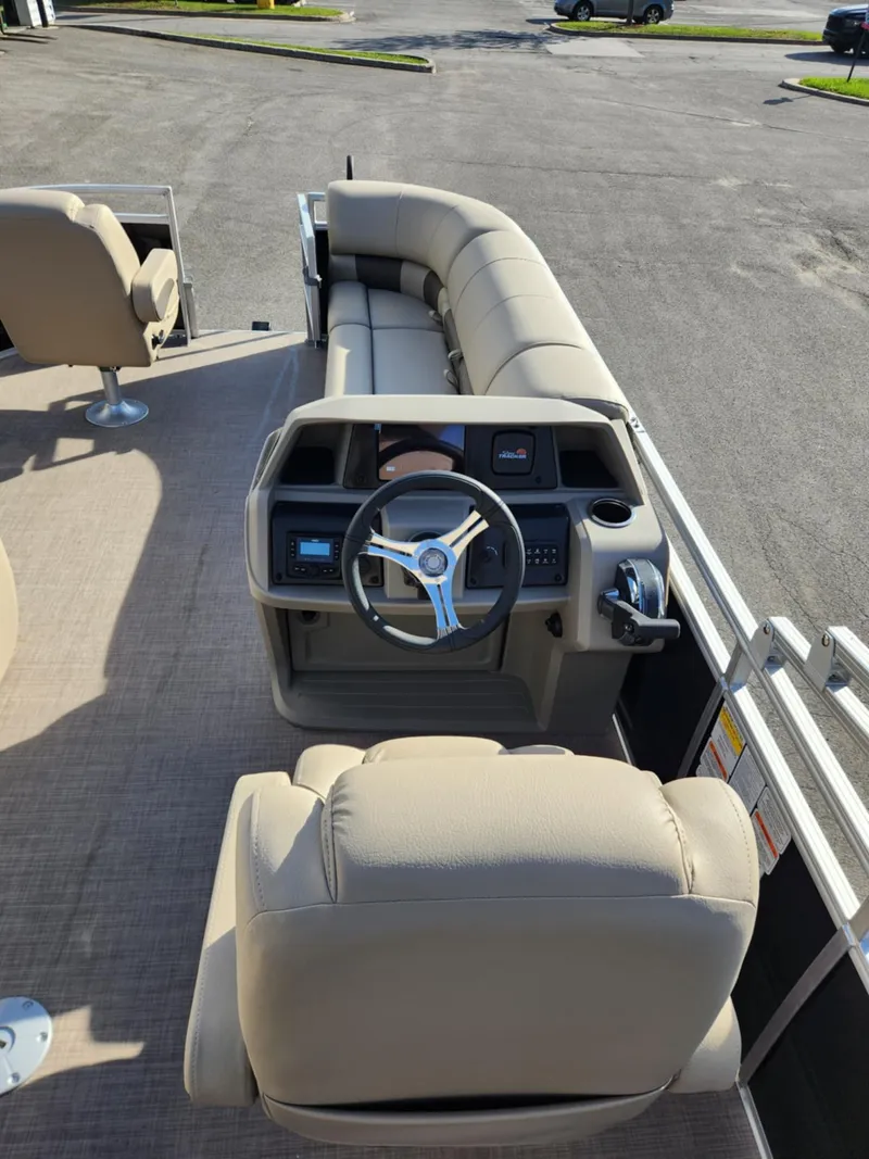 Slide: The Image of 2025 Sun Tracker SportFish 20 DLX pontoon boat interior with steering console and seating. - 5