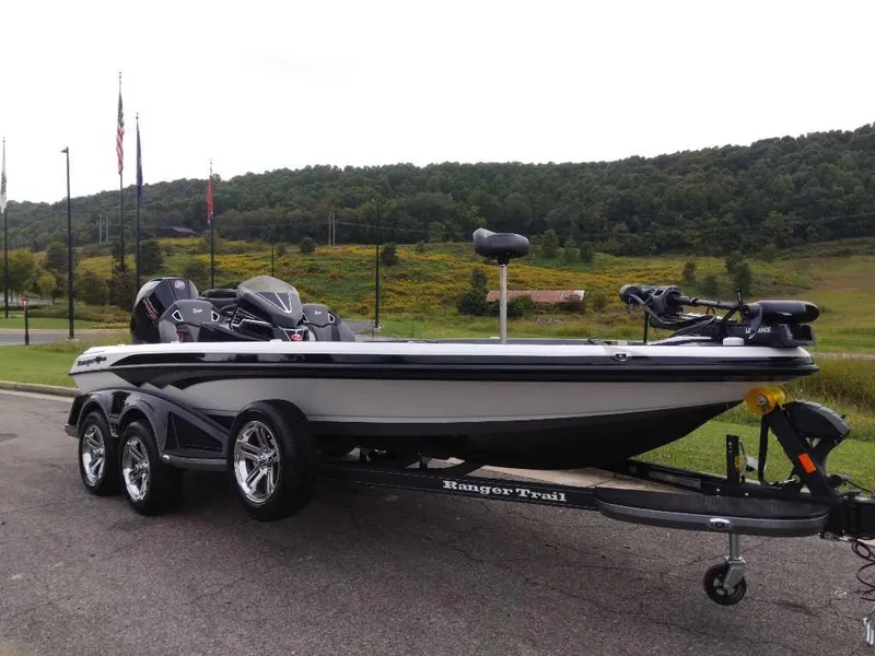 Slide: The Image of 2024 Ranger Z520R Ranger Cup Equipped boat on trailer, parked outdoors with scenic background. - 1