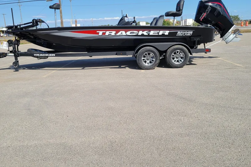 The Image of 2025 Tracker Savage 215 boat on trailer in parking lot, side view. - 0