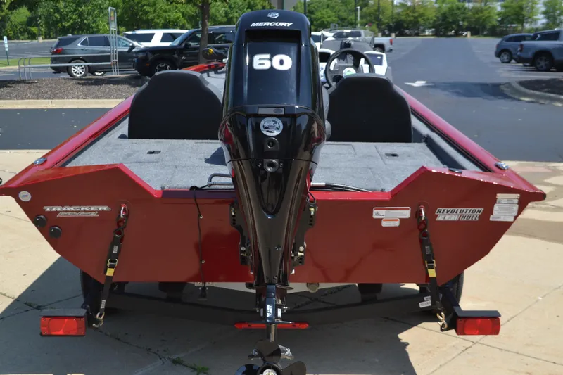 Slide: The Image of 2025 Tracker Pro Team 175 boat with Mercury 60 engine, parked on pavement. - 2