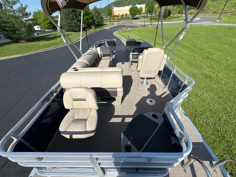 Slide: The Image of 2025 Sun Tracker Fishin' Barge 20 DLX pontoon boat with beige seating and canopy. - 5