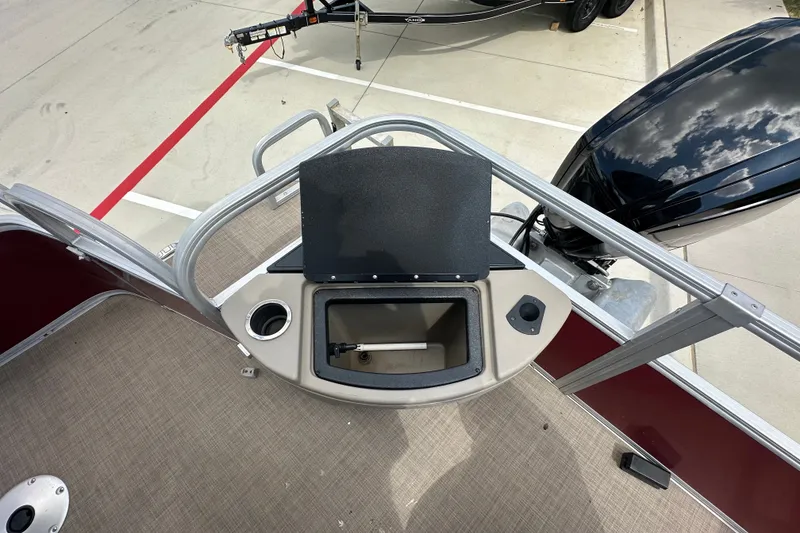 Slide: The Image of 2024 Regency 230 LE3 boat deck with storage compartment and motor. - 5