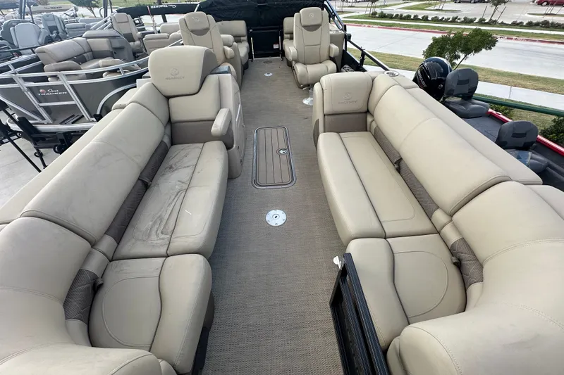 Slide: The Image of Luxurious seating on 2024 Regency 230 LE3 pontoon boat, featuring spacious beige upholstery. - 15