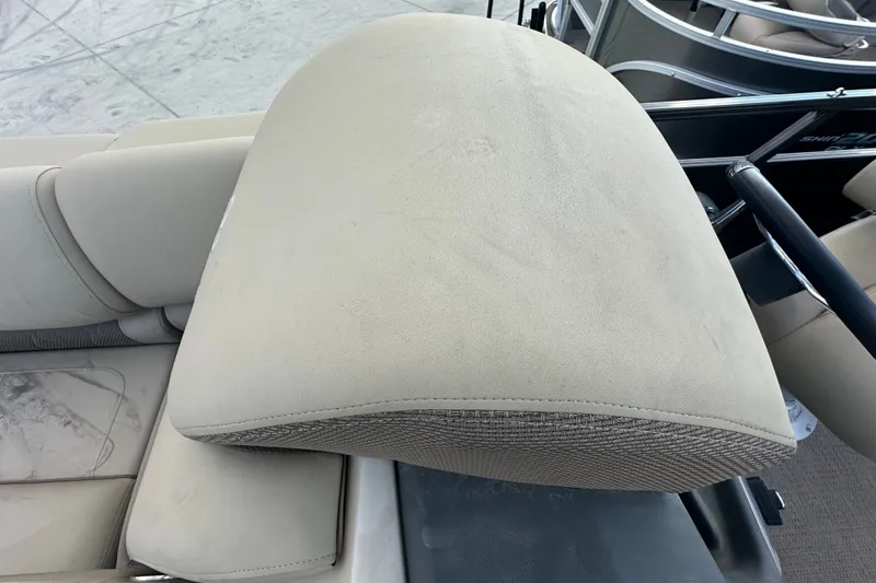 Slide: The Image of 2024 Regency 230 LE3 boat seat with beige upholstery and sleek design. - 19