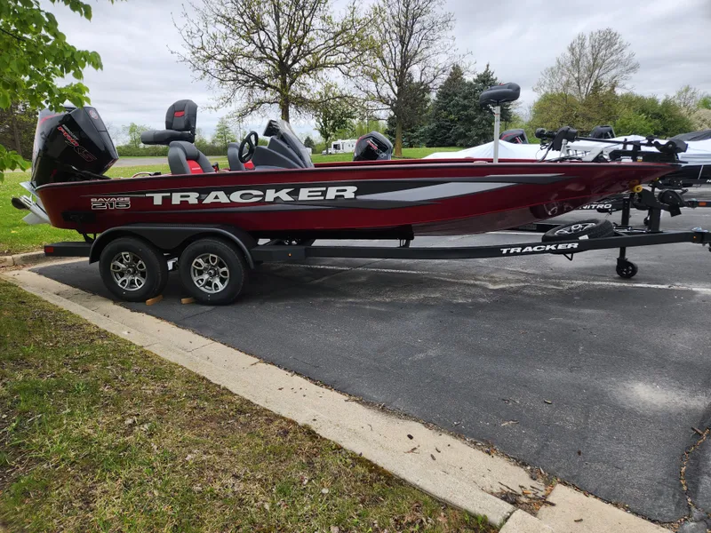The Image of 2025 Tracker Savage 215 boat on trailer, parked outdoors, featuring sleek red and black design. - 0