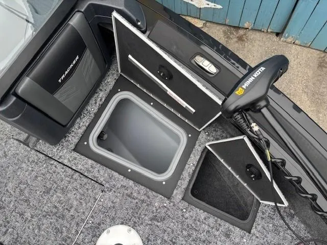 Slide: The Image of 2025 Tracker Targa V-19 Combo boat deck with storage compartments and Minn Kota trolling motor. - 10