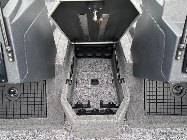 Slide: The Image of 2025 Tracker Targa V-19 Combo boat storage compartment with open lid, showcasing interior space. - 13