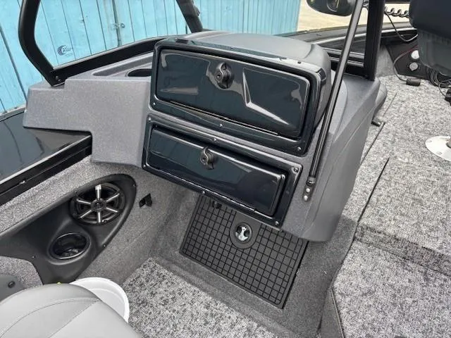 Slide: The Image of 2025 Tracker Targa V-19 Combo boat interior with storage compartments and speaker. - 14