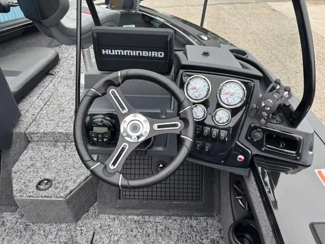 Slide: The Image of 2025 Tracker Targa V-19 Combo boat dashboard with steering wheel and gauges. - 16