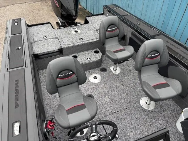 Slide: The Image of 2025 Tracker Targa V-19 Combo boat interior with gray seating and steering wheel. - 20