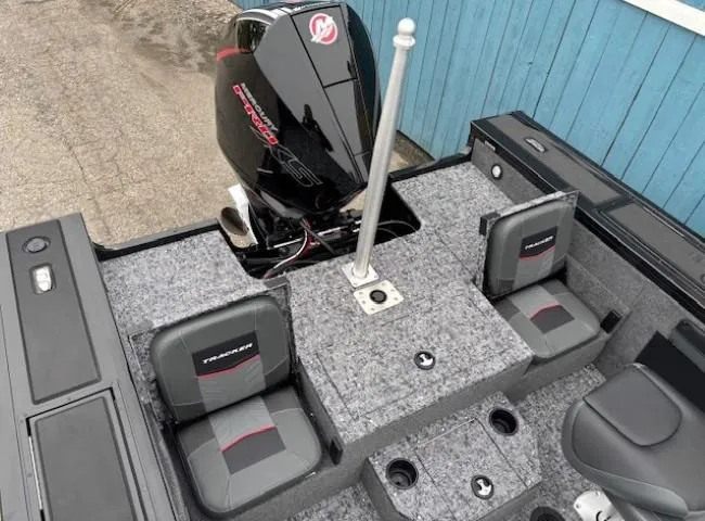 Slide: The Image of 2025 Tracker Targa V-19 Combo boat interior with seating and motor, featuring a modern design. - 22