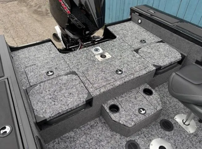 Slide: The Image of 2025 Tracker Targa V-19 Combo boat interior with carpeted deck and motor. - 23