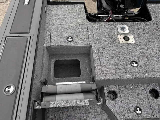 Slide: The Image of 2025 Tracker Targa V-19 Combo boat interior with storage compartments and seating. - 24