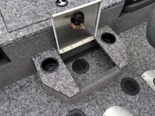 Slide: The Image of 2025 Tracker Targa V-19 Combo boat interior with cup holders and storage compartments. - 26