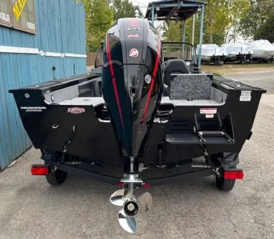 Slide: The Image of 2025 Tracker Targa V-19 Combo boat, rear view, parked outdoors. - 4