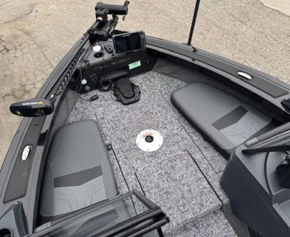 Slide: The Image of 2025 Tracker Targa V-19 Combo boat interior with gray seating and advanced controls. - 7