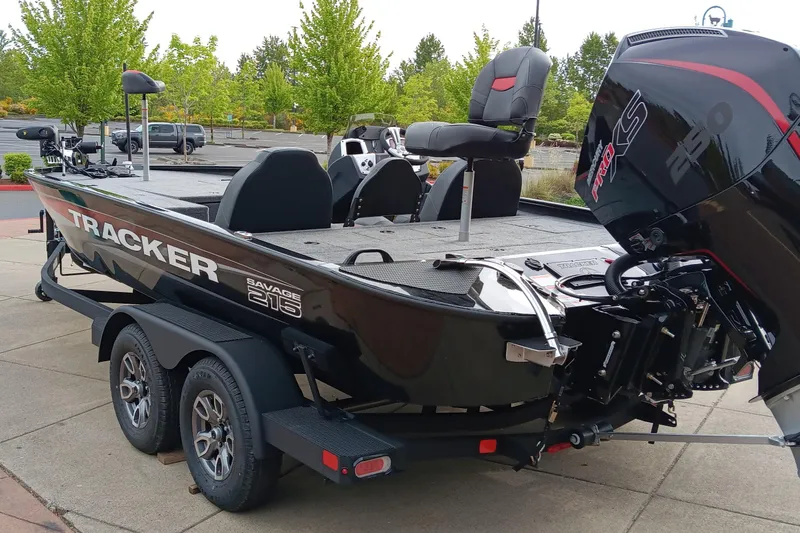 Slide: The Image of 2025 Tracker Savage 215 boat on trailer, featuring sleek design and powerful engine. - 3