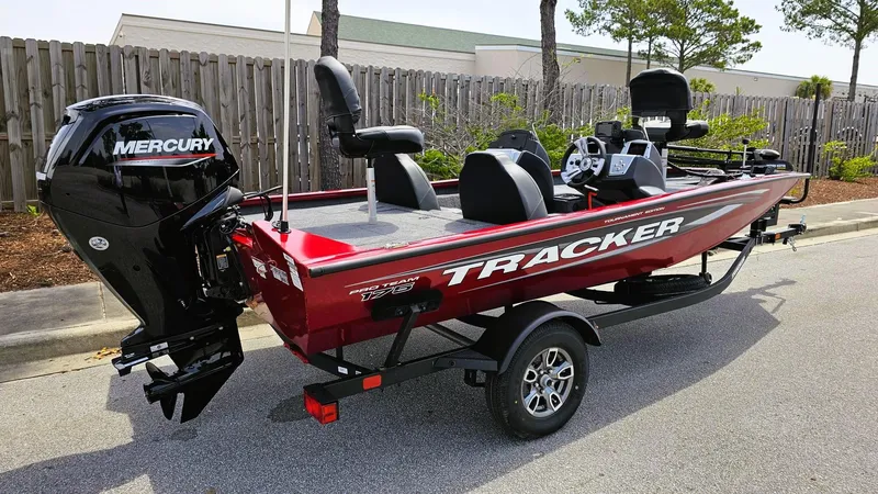 Slide: The Image of 2025 Tracker Pro Team 175 boat with Mercury engine, parked on a trailer. - 2