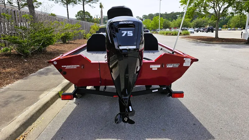 Slide: The Image of 2025 Tracker Pro Team 175 boat with Mercury 75 engine, parked on a street. - 4