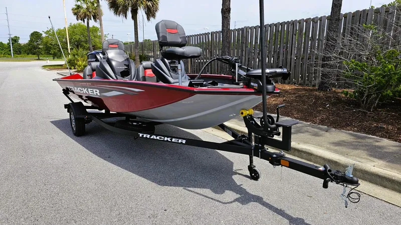 Slide: The Image of 2025 Tracker Pro Team 175 boat on trailer, parked on a street. - 6