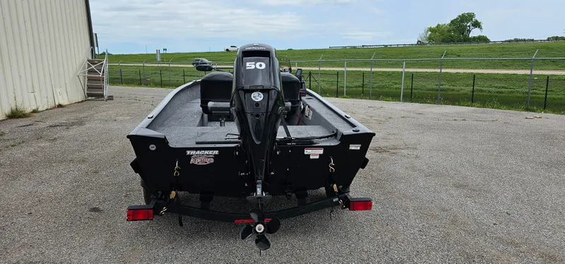 Slide: The Image of 2025 Tracker Super Guide V-16 SC boat with 50 HP motor, parked outdoors. - 3