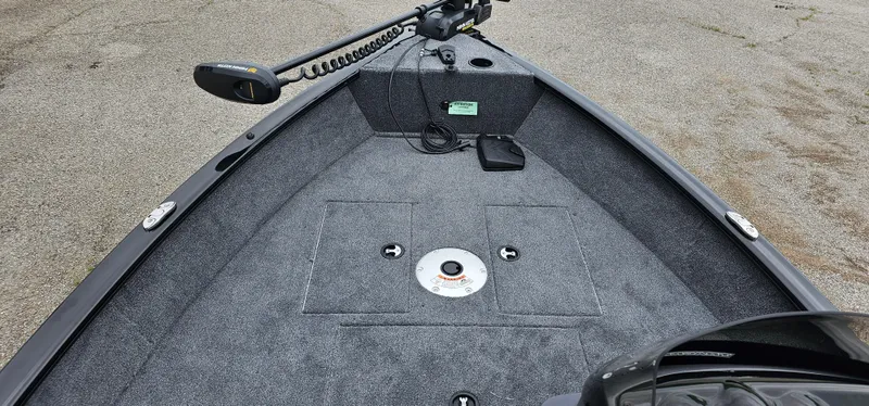 Slide: The Image of 2025 Tracker Super Guide V-16 SC boat interior with carpeted deck and trolling motor. - 4