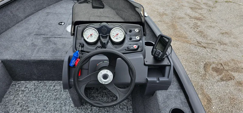 Slide: The Image of 2025 Tracker Super Guide V-16 SC boat dashboard with steering wheel and gauges. - 6